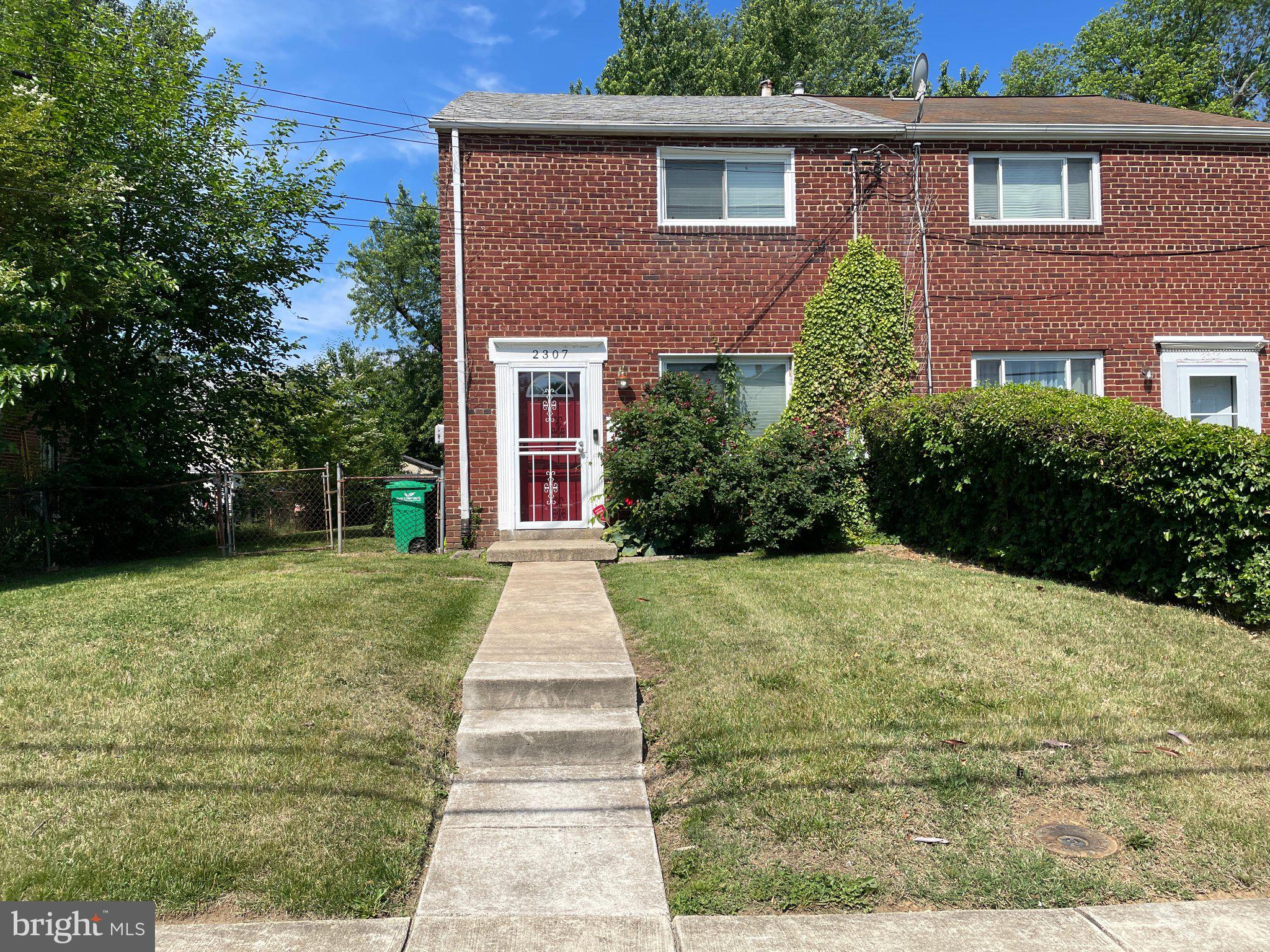 2307 Wyngate Road Suitland, MD 20746 - Photo 1 of 22 a front view of a house with garden