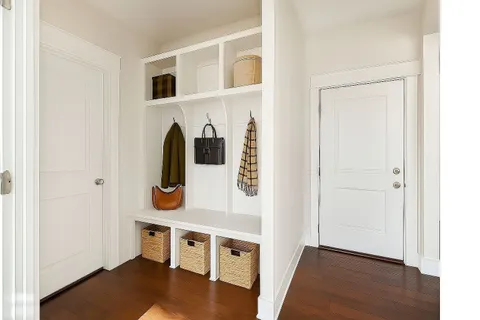 a view of an entryway with wooden floor and door