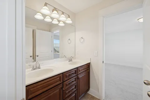 a bathroom with a sink a light fixture and a mirror