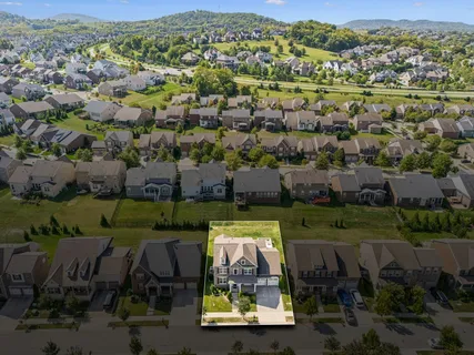 an aerial view of a houses with a yard