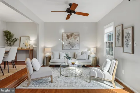 a living room with furniture and a lamp
