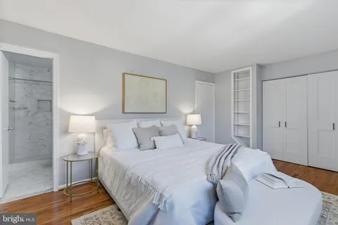 a bedroom with a bed and a lamp