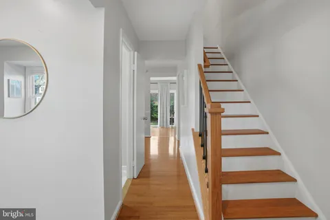 a view of a hallway with wooden floor and entryway