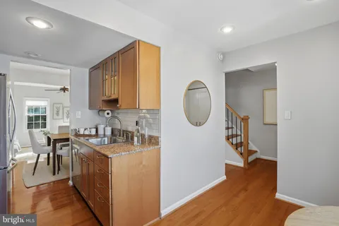 a view of a kitchen cabinets a sink and wooden floor