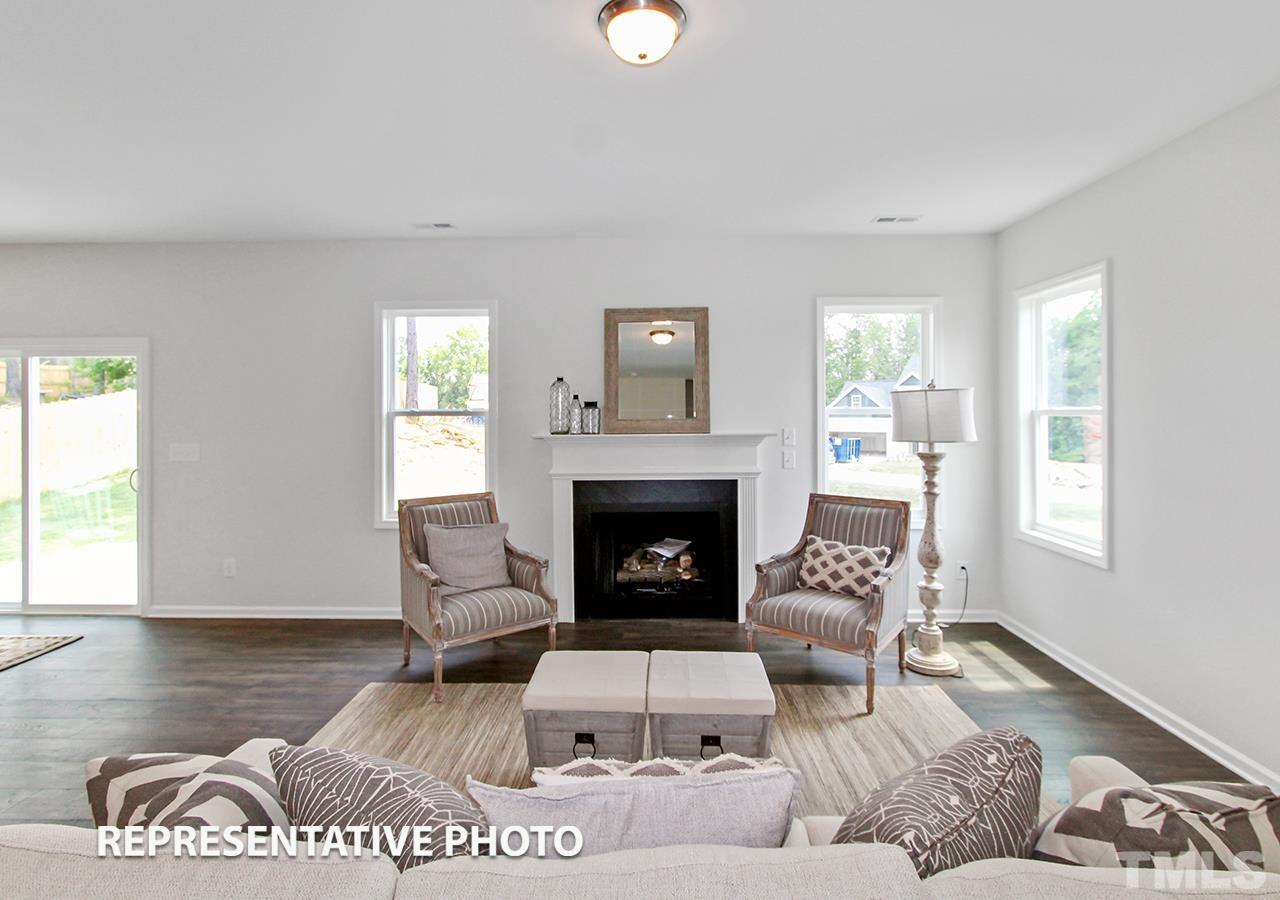 67 Weathervane Dr. Zebulon, NC 27597 - Photo 5 of 10 a living room with furniture and a fireplace