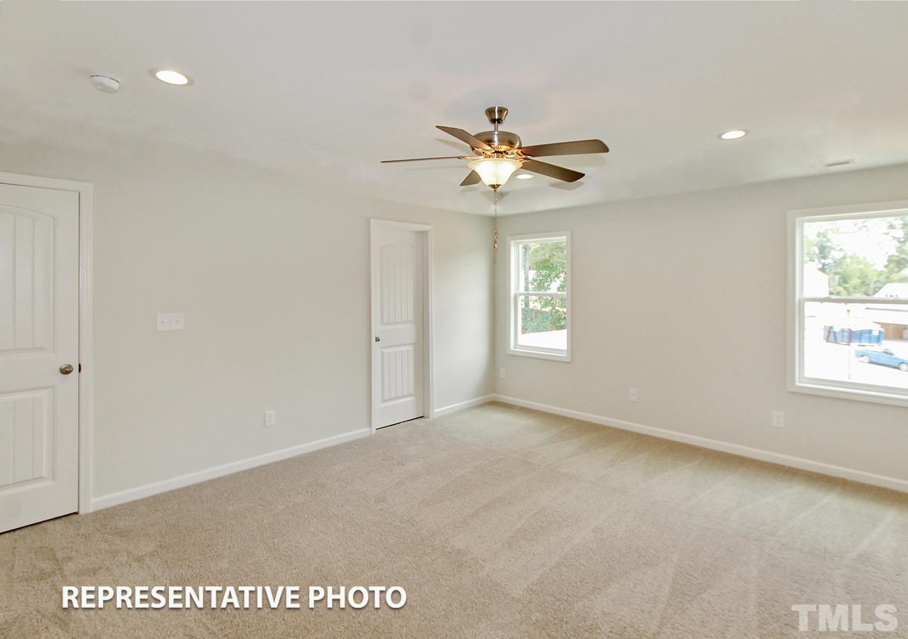 67 Weathervane Dr. Zebulon, NC 27597 - Photo 7 of 10 an empty room with windows and fan