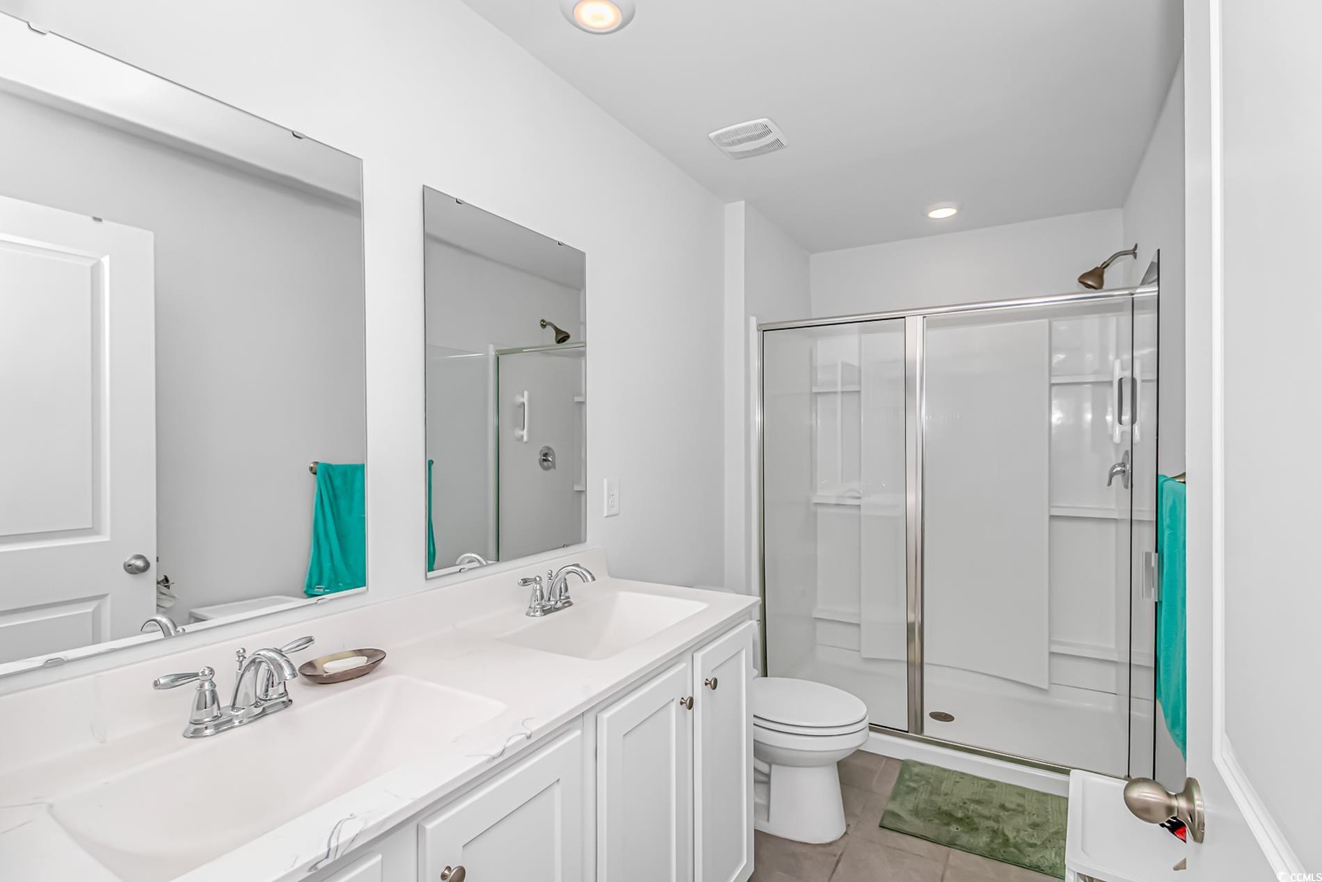 559 Courtridge Loop Conway, SC 29526 - Photo 12 of 37 Bathroom featuring vanity, toilet, an enclosed shower, and tile patterned flooring