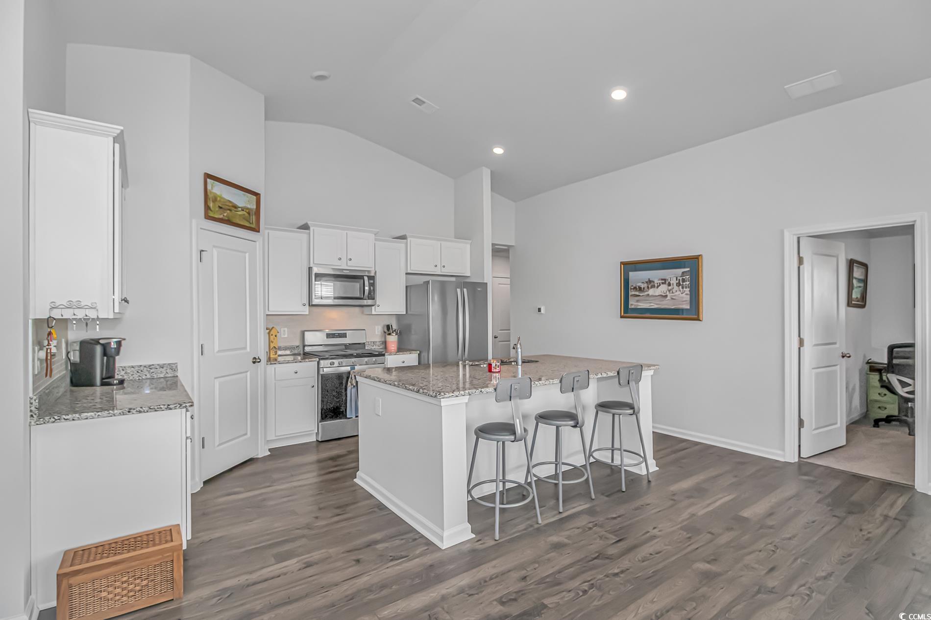 559 Courtridge Loop Conway, SC 29526 - Photo 3 of 37 Kitchen with a center island with sink, light stone countertops, white cabinets, and appliances with stainless steel finishes
