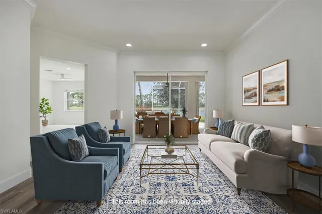 a living room with furniture ceiling fan and a rug