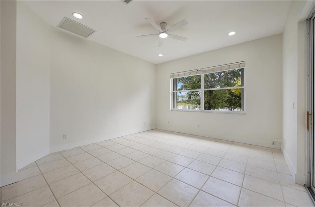 1087 Port Orange Way Naples, FL 34120 - Photo 17 of 50 an empty room with windows and fan