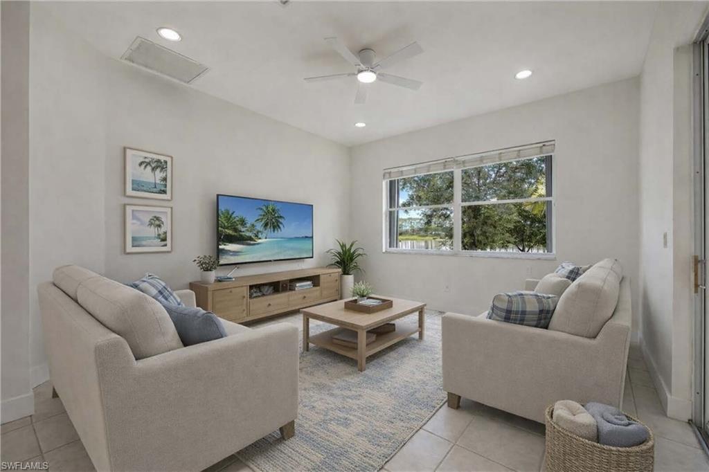 1087 Port Orange Way Naples, FL 34120 - Photo 17 of 50 Virtually staged family room with a ceiling fan, light tile patterned floors, and recessed lighting