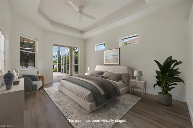 a bedroom with a large bed and a potted plant