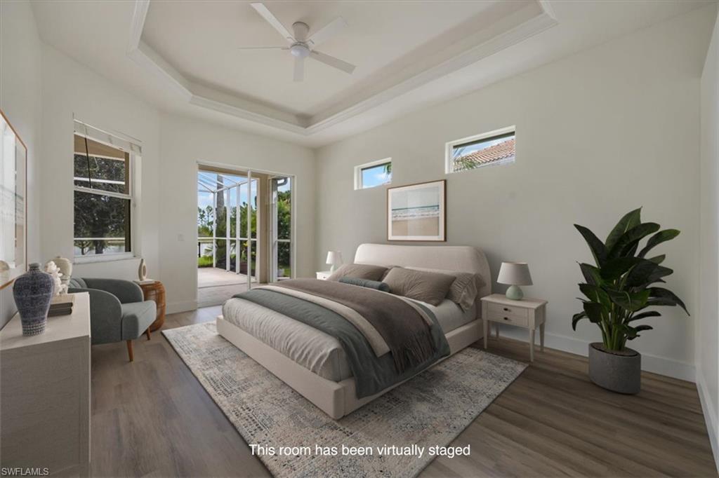 1087 Port Orange Way Naples, FL 34120 - Photo 18 of 50 a bedroom with a large bed and a potted plant