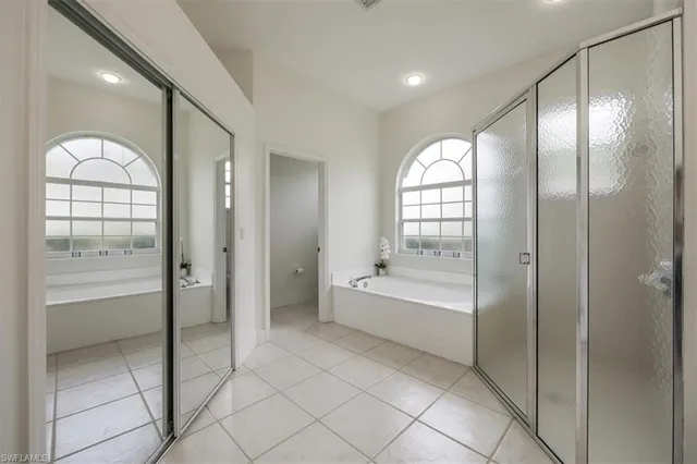 a spacious bathroom with a bathtub and a shower