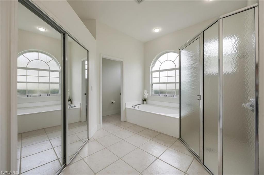 1087 Port Orange Way Naples, FL 34120 - Photo 22 of 50 a spacious bathroom with a bathtub and a shower