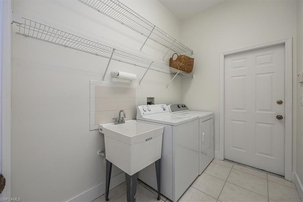 1087 Port Orange Way Naples, FL 34120 - Photo 31 of 50 a utility room with dryer and washer