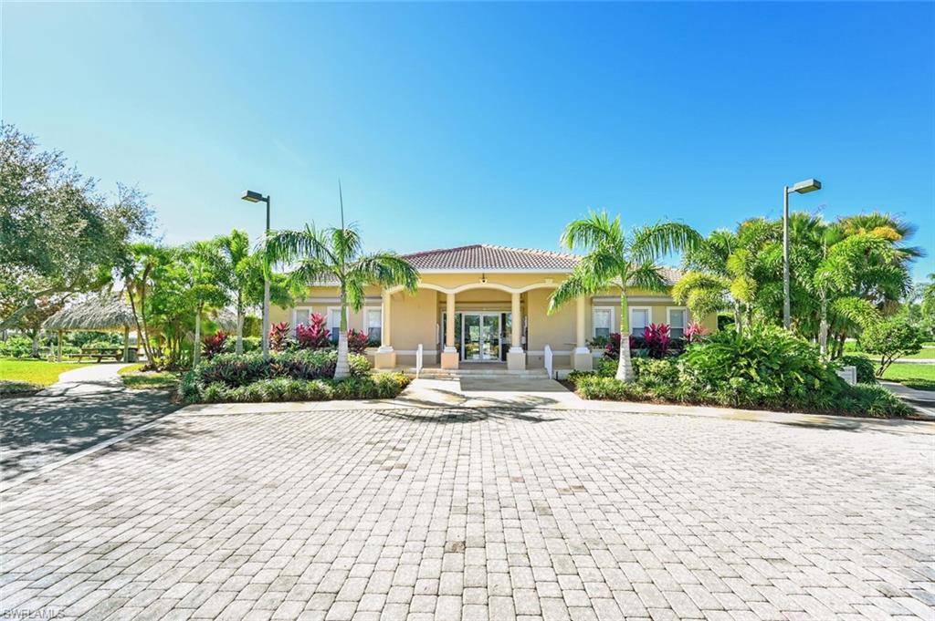 1087 Port Orange Way Naples, FL 34120 - Photo 38 of 50 a front view of a house with garden