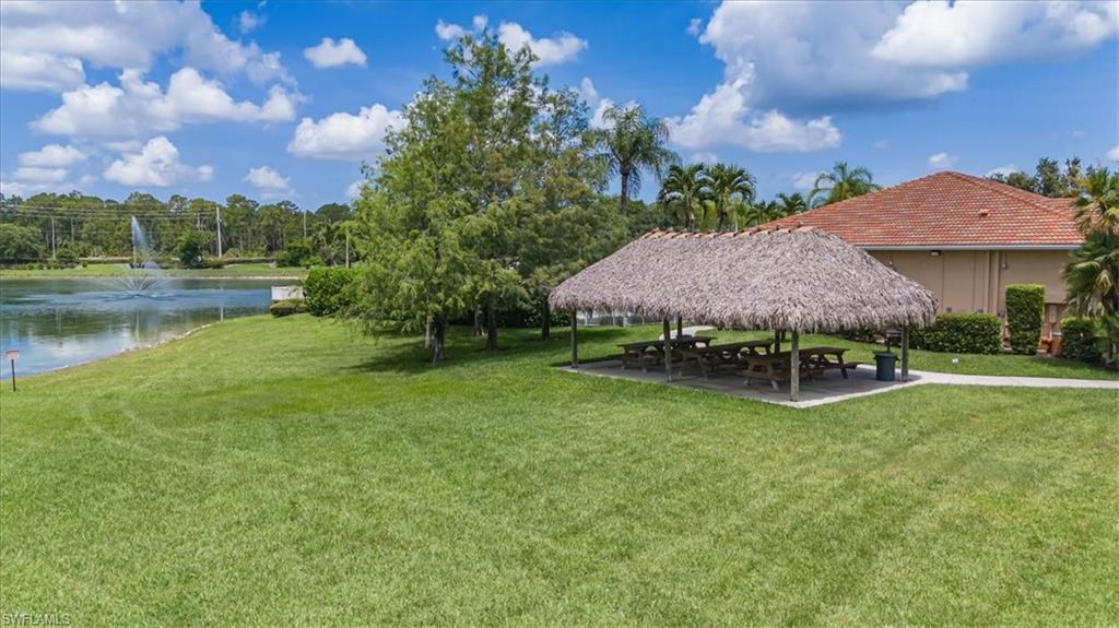 1087 Port Orange Way Naples, FL 34120 - Photo 46 of 50 a view of a garden with a lake