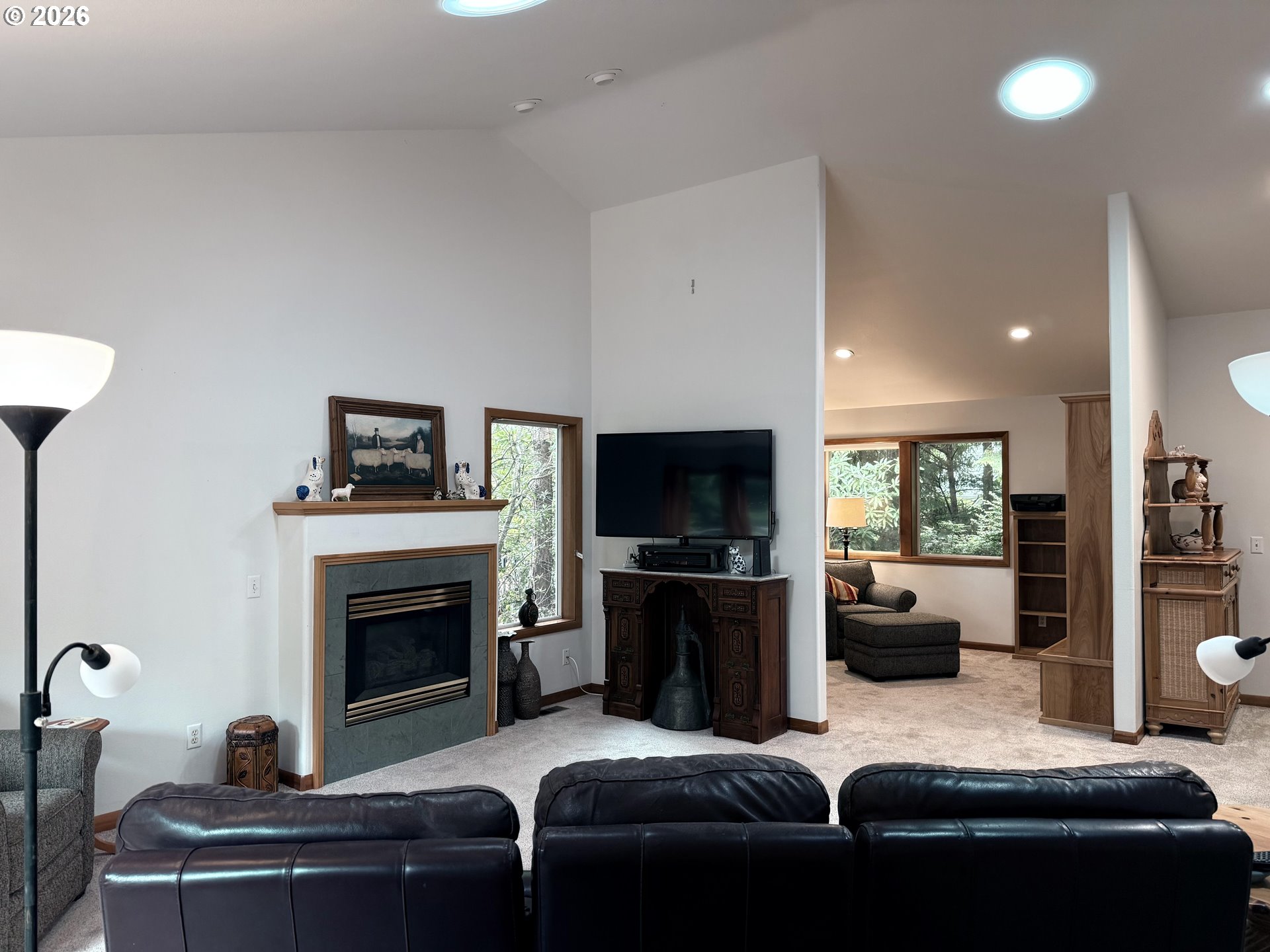 95 Cormorant Depoe Bay, OR 97341 - Photo 11 of 48 a living room with furniture a flat screen tv and a fireplace