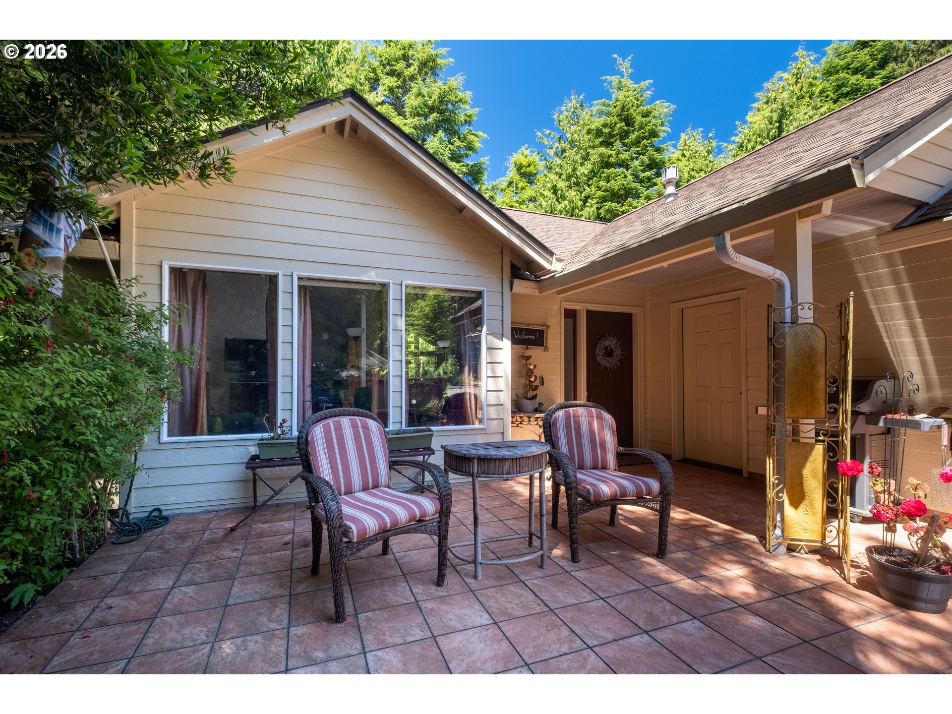 95 Cormorant Depoe Bay, OR 97341 - Photo 4 of 48 a backyard of a house with barbeque oven table and chairs
