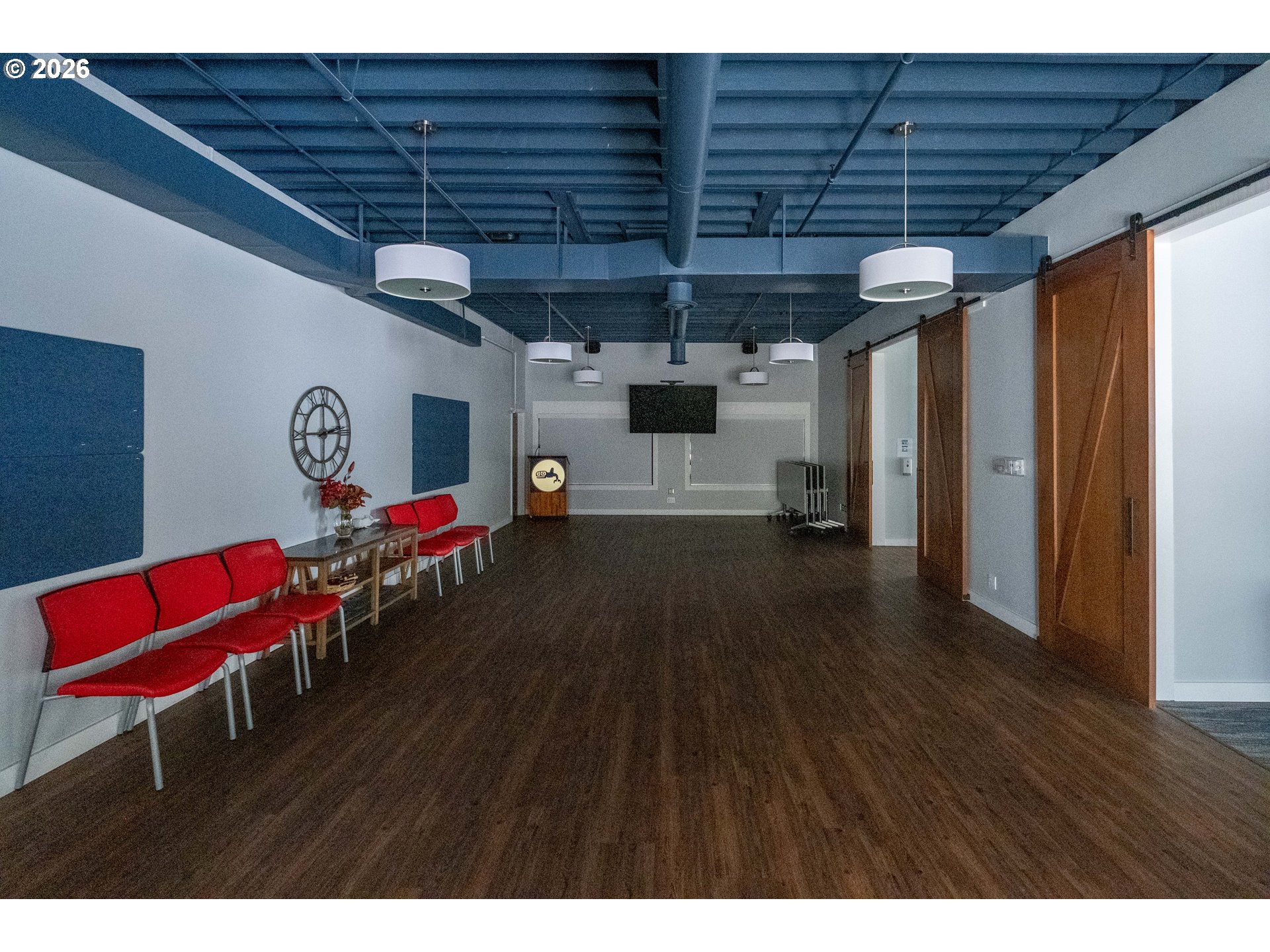 95 Cormorant Depoe Bay, OR 97341 - Photo 42 of 48 a hallway with a table and a chair with wooden floor