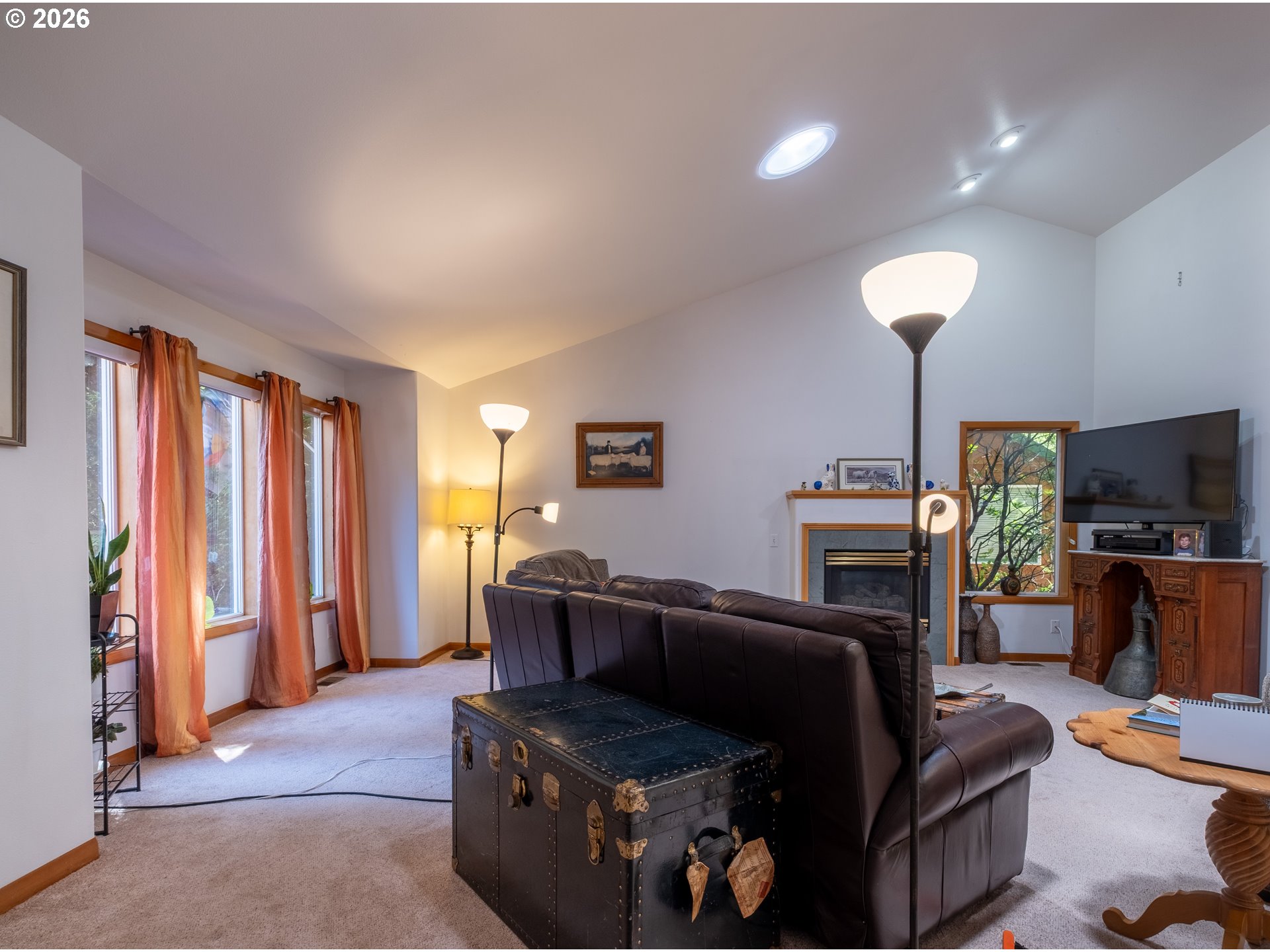 95 Cormorant Depoe Bay, OR 97341 - Photo 9 of 48 a living room with furniture a flat screen tv and a fireplace