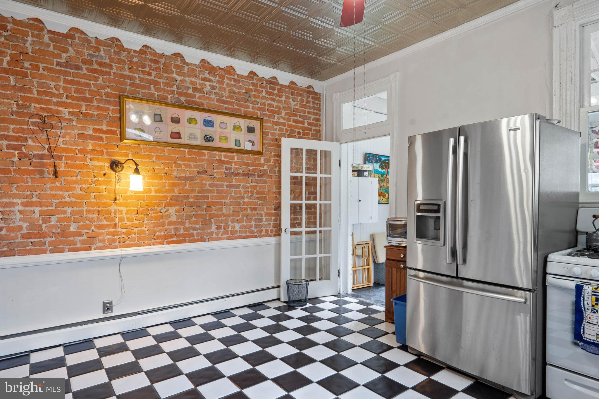 407 Savannah Road Lewes, DE 19958 - Photo 11 of 28 a kitchen with granite countertop a refrigerator and a stove