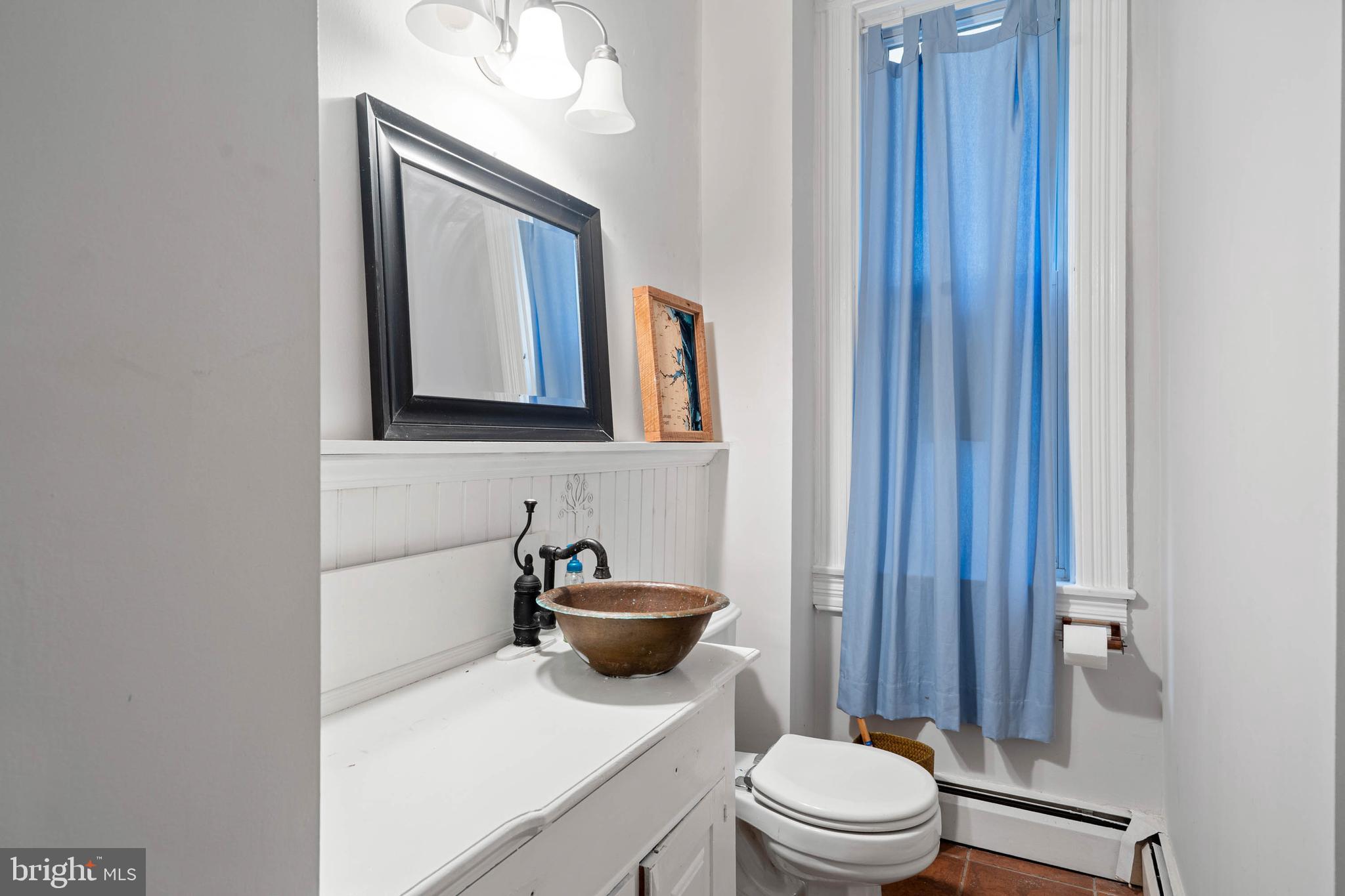 407 Savannah Road Lewes, DE 19958 - Photo 14 of 28 a bathroom with a toilet a sink and mirror