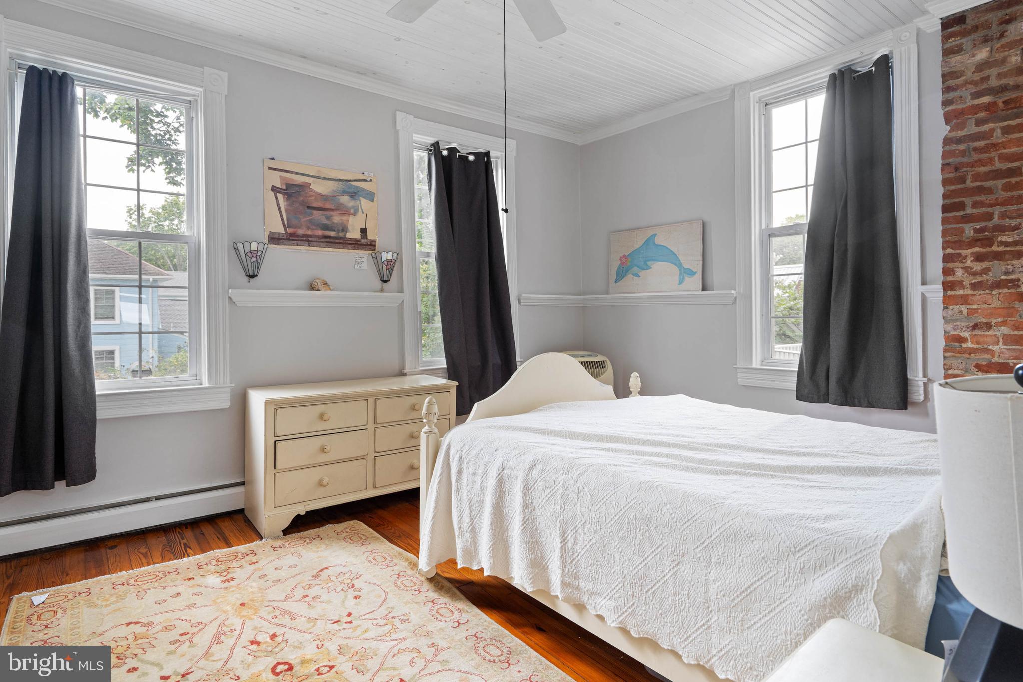 407 Savannah Road Lewes, DE 19958 - Photo 15 of 28 a bedroom with a bed and a dresser