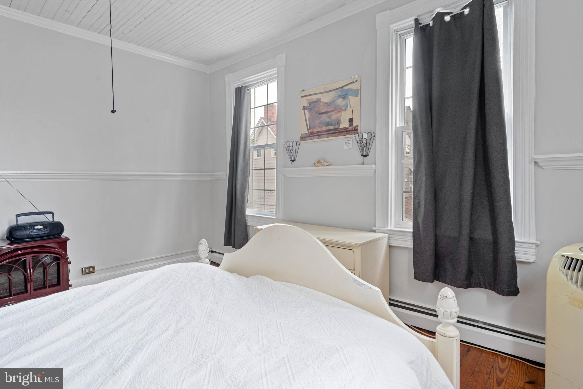 407 Savannah Road Lewes, DE 19958 - Photo 16 of 28 a bedroom with a bed and wooden floor