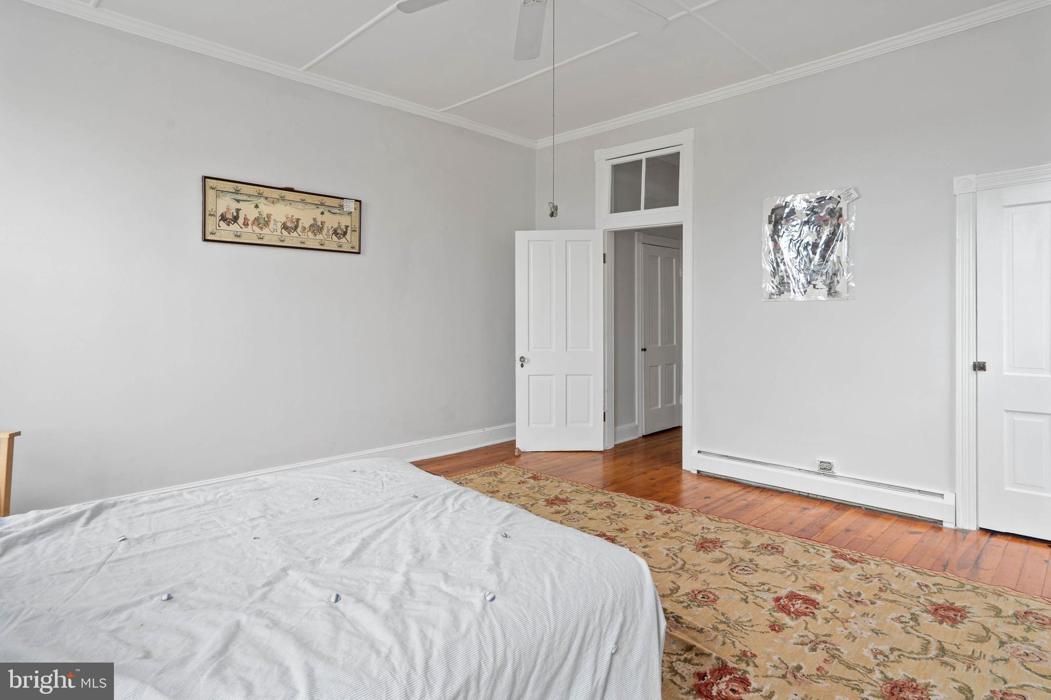 407 Savannah Road Lewes, DE 19958 - Photo 18 of 28 a bedroom with a bed and painting on the wall