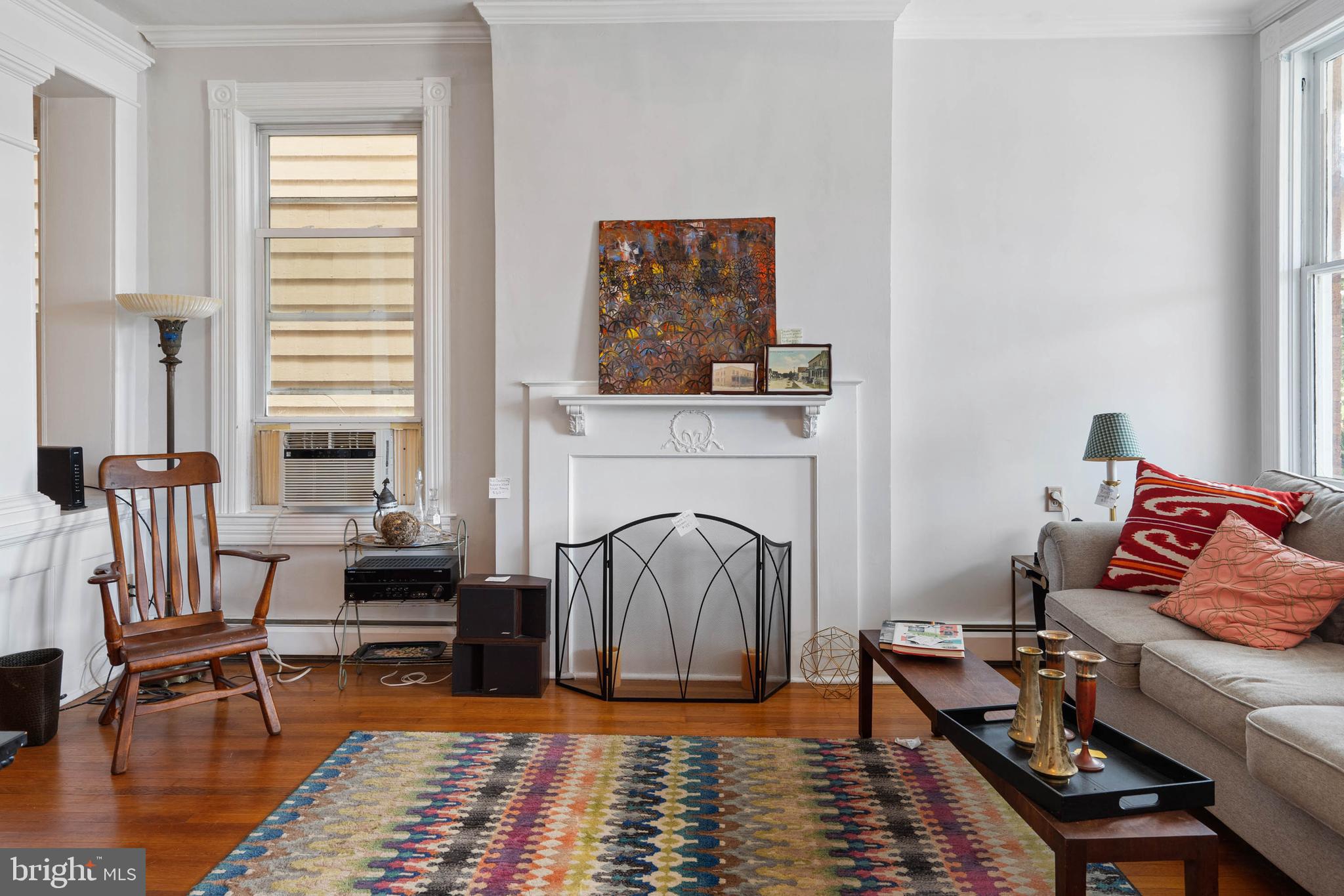 407 Savannah Road Lewes, DE 19958 - Photo 3 of 28 a living room with furniture a rug and a fireplace