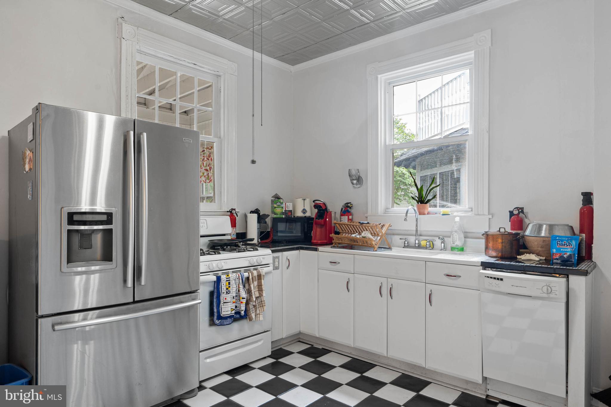 407 Savannah Road Lewes, DE 19958 - Photo 10 of 28 a kitchen with stainless steel appliances a sink stove and refrigerator