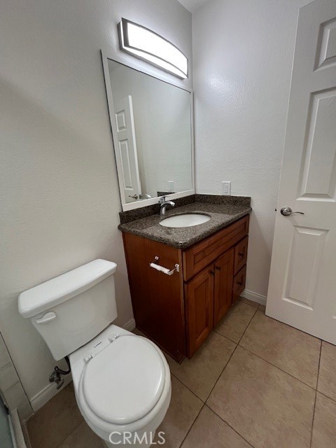 45 Golden Glen Street, Unit 75 Irvine, CA 92604 - Photo 14 of 35 a bathroom with a granite countertop toilet sink and mirror