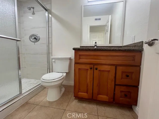 a white toilet sitting next to a shower