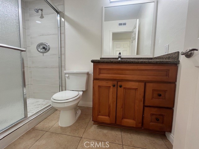45 Golden Glen Street, Unit 75 Irvine, CA 92604 - Photo 17 of 35 a bathroom with a toilet a sink and mirror