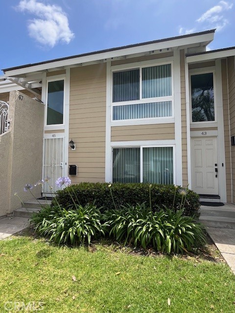 45 Golden Glen Street, Unit 75 Irvine, CA 92604 - Photo 2 of 35 a front view of a house with a yard