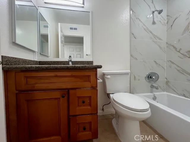 a bathroom with a toilet and a bathtub