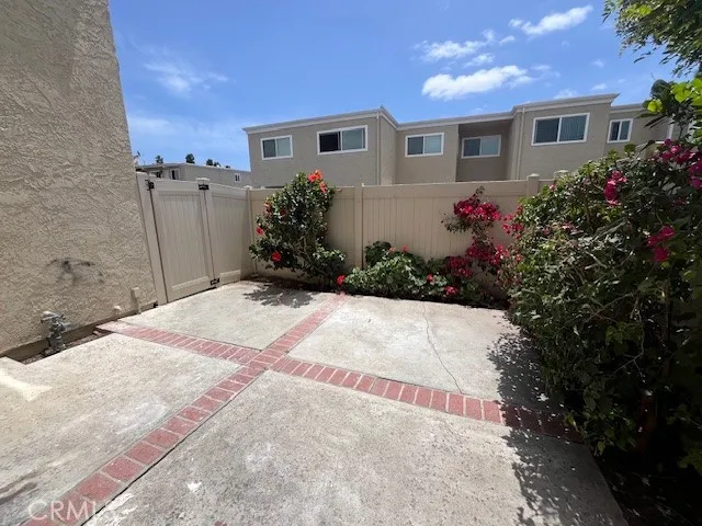 a view of a patio with table and chairs potted plants and large tree