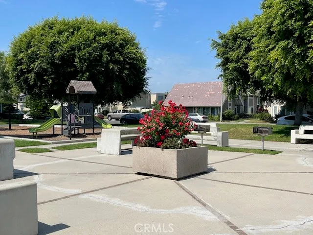 a view of a tennis ground with large trees