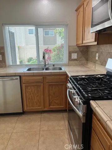 a kitchen with a stove sink and window