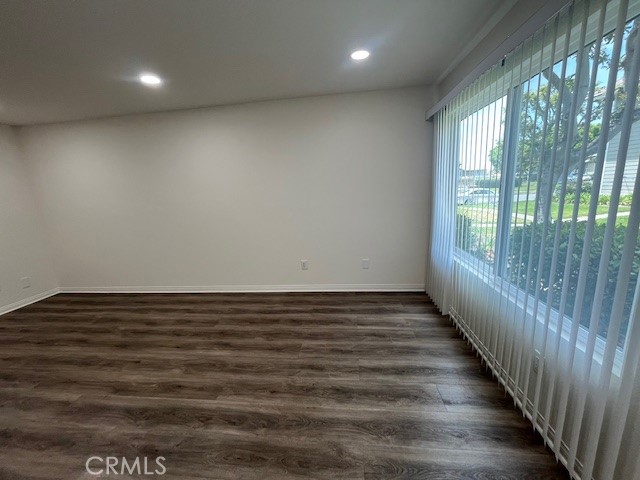 45 Golden Glen Street, Unit 75 Irvine, CA 92604 - Photo 9 of 35 an empty room with wooden floor and windows