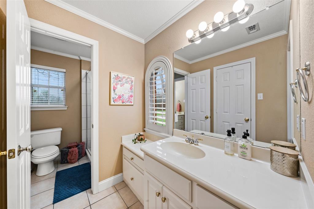 517 Chado Lane Robinson, TX 76706 - Photo 25 of 40 Bathroom #2 featuring a shower stall, crown molding, vanity, and light tile patterned floors