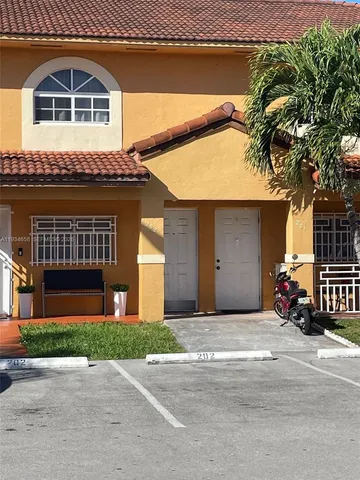 front view of a house with a garden