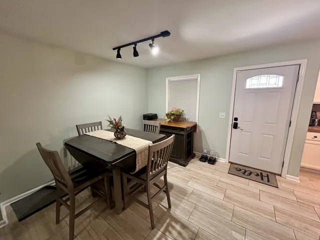a view of a dining room with furniture and wooden floor