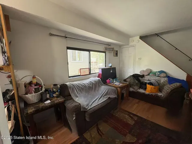 a living room with furniture a bed and a window