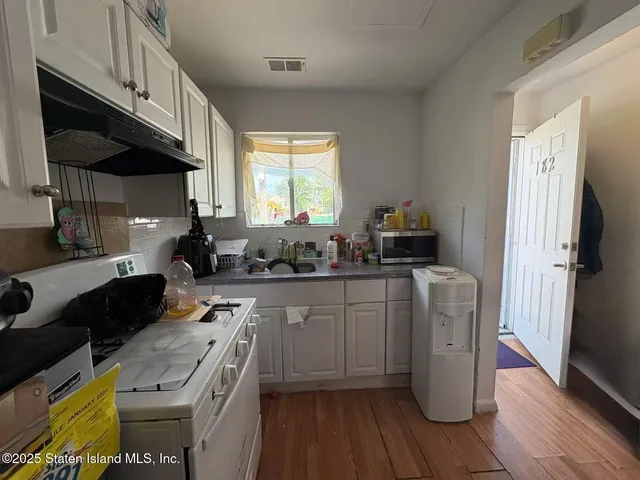 a kitchen with stainless steel appliances granite countertop a stove a sink dishwasher and a refrigerator