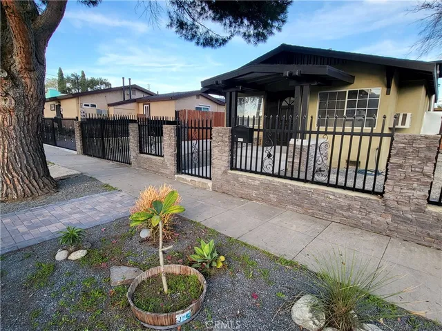 a view of a house with wooden fence