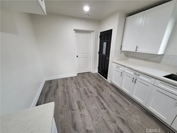a view of a kitchen with wooden floor