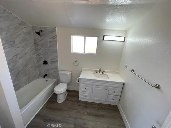 a bathroom with a double vanity sink toilet and shower